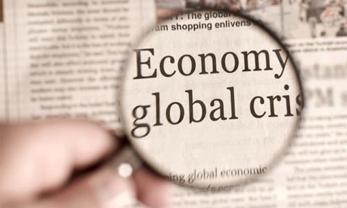 Magnifying glass on Economy global crisis news article