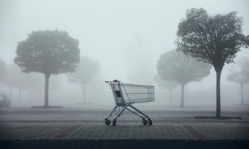 An empty cart in a foggy forest