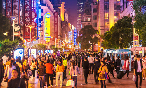 A busy walking street in Shanghai at night